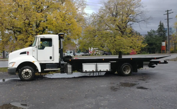 Metro FB-10 flatbed carrier side view parked with autumn background