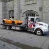 Metro FB-10 rollback flatbed transporting a Lamborghini supercar in city streets