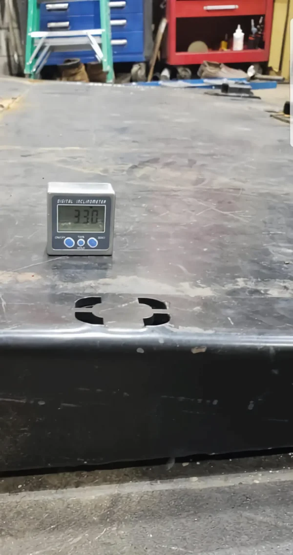 Metro FB-10 rollback deck tilt angle measurement with gauge showing steel platform