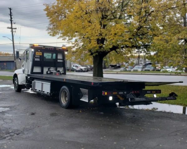 Metro FB-10 rollback tow truck rear angle showing steel deck and wheel lift