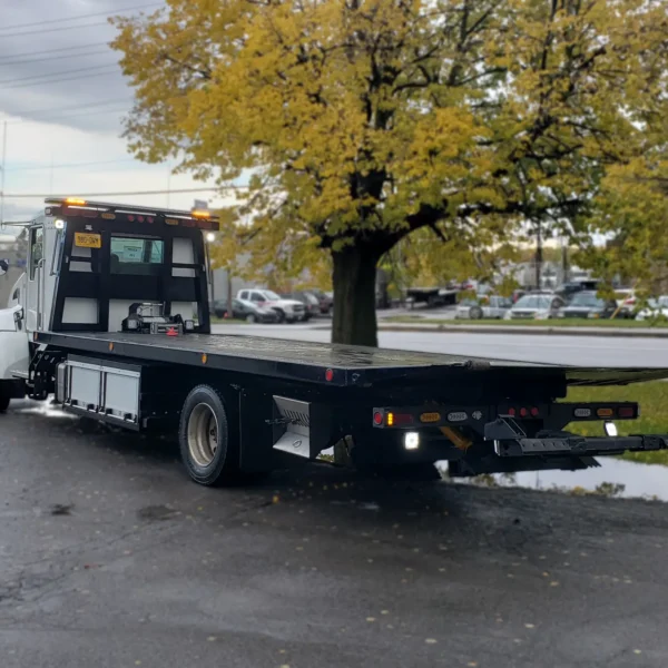Metro FB-10 rollback tow truck rear angle showing steel deck and wheel lift