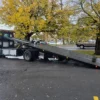 Metro FB-10 flatbed with hydraulic tilt deck extended for vehicle loading