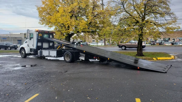 Metro FB-10 flatbed with hydraulic tilt deck extended for vehicle loading
