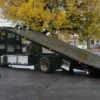 Metro FB-10 flatbed tow truck with fully extended tilt deck for vehicle loading