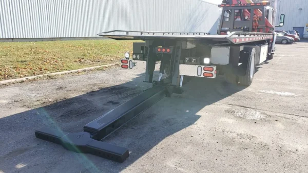 Metro FB-15 flatbed tow truck wheel lift extended for vehicle towing support