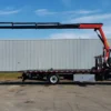 Metro FB-15 flatbed truck with knuckle boom crane fully extended horizontally
