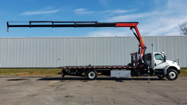 Metro FB-15 flatbed truck with knuckle boom crane fully extended horizontally