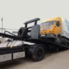 Metro FB-15 flatbed towing and loading a medium-duty commercial truck