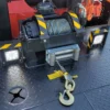 Metro FB-15 hydraulic deck winch with steel cable and towing hook close-up