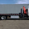 Metro FB-15 long-bed flatbed tow truck side view with rear underlift and crane system
