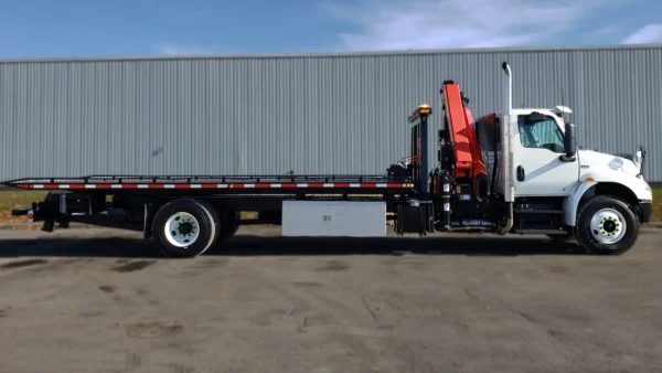 Metro FB-15 long-bed flatbed tow truck side view with rear underlift and crane system