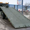 Metro FB-15 tilt-deck recovery truck with hydraulic slide bed deployed on snowy ground