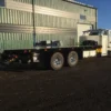 Metro FB-15 flatbed tow truck side view with long wheelbase and dual rear axles