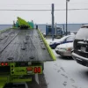 Metro FB-20 heavy-duty flatbed tow truck with extended steel deck in snowy yard