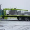 Metro FB-20 flatbed tow truck side view in snowy parking lot