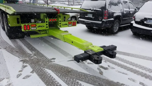 Metro FB-20 heavy-duty under-reach towing attachment extended behind truck in snow
