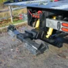 Metro FB-20 rear hydraulic underlift system with stabilizers deployed on gravel lot