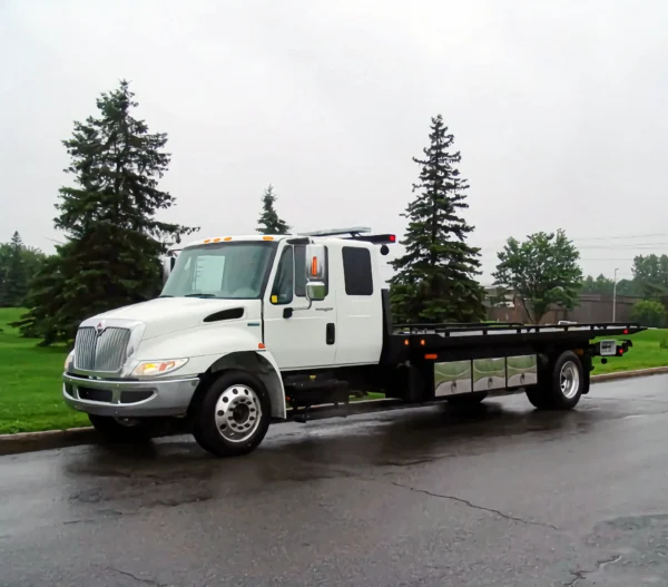 Metro Flatbed FB-5 straight-truck carrier parked roadside ready for vehicle transport