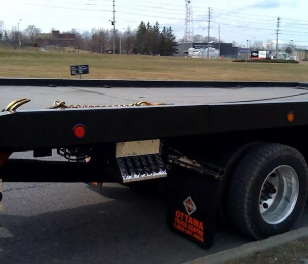 Metro Flatbed FB-5 carrier rear deck and wheel lift safety equipment close-up