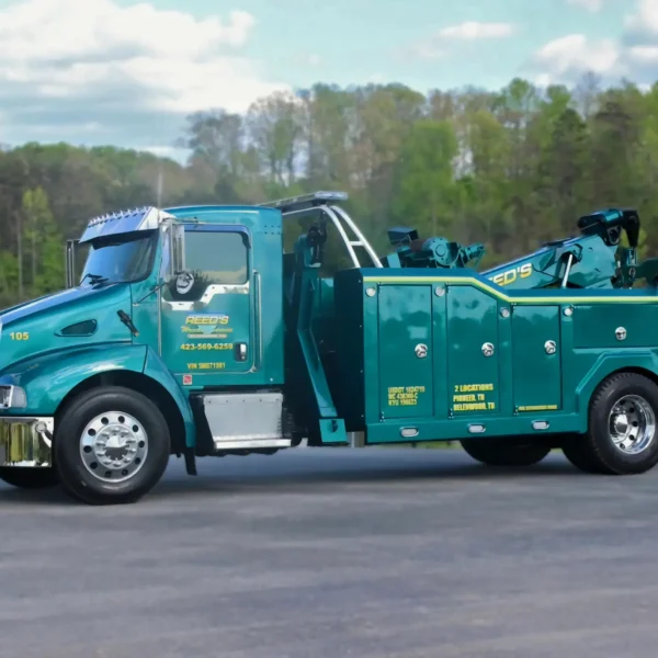 Metro Tow Trucks INT-16 teal heavy-duty integrated wrecker left side view parked on pavement