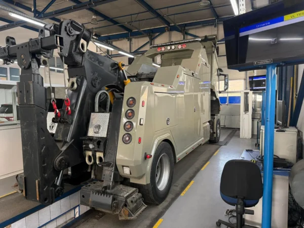 Metro Tow Trucks INT-16 beige heavy-duty integrated wrecker rear side view during maintenance inside workshop