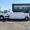 Metro Tow Trucks INT-16 white heavy-duty integrated wrecker left side view parked in front of industrial building