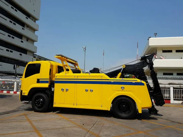 Metro Tow Trucks INT-16 yellow heavy-duty integrated wrecker left side profile in outdoor service area