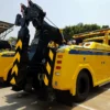 Metro Tow Trucks INT-16 yellow heavy-duty integrated wrecker rear angled view with boom and wheel-lift system