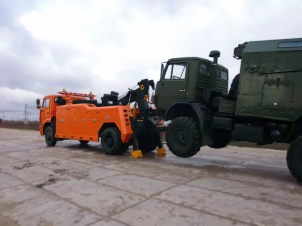 Metro Tow Trucks INT-16 orange heavy-duty tow truck lifting military truck during recovery demonstration