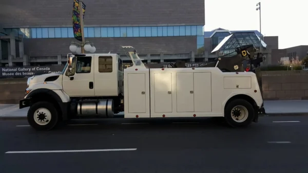 Metro Tow Trucks INT-16 white heavy-duty integrated wrecker left side profile parked beside road