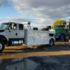 Metro Tow Trucks INT-16 white heavy-duty integrated wrecker in wet roadside environment