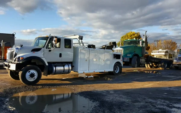 Metro Tow Trucks INT-16 white heavy-duty integrated wrecker in wet roadside environment