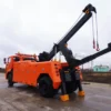 Metro Tow Trucks INT-16 orange integrated wrecker boom extended during lifting operation in yard