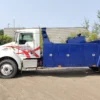 Metro Tow Trucks INT-16 white and blue heavy-duty integrated wrecker left side profile on dirt surface