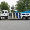 INT-35 heavy-duty wrecker with tool compartments open showing recovery and towing equipment storage