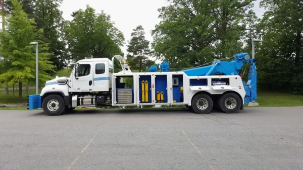 INT-35 heavy-duty wrecker with tool compartments open showing recovery and towing equipment storage