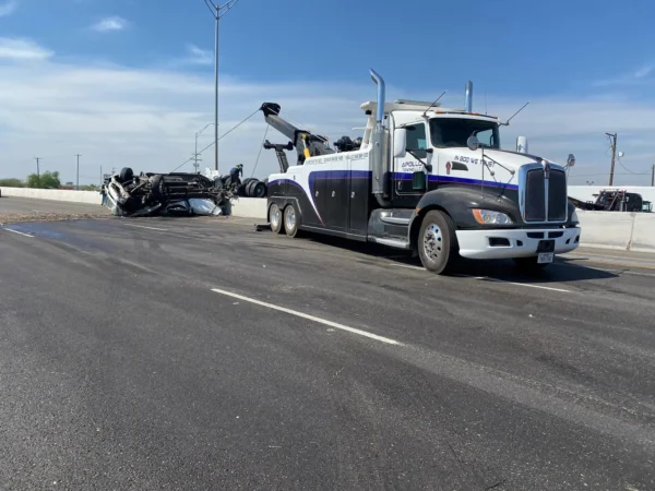 INT-35 heavy-duty tow truck performing roadside recovery of a disabled vehicle on public roadway