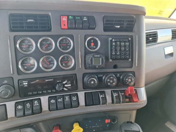 Driver dashboard and recovery control switches inside INT-35 wrecker cab interior
