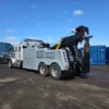 Side view of INT-35 heavy wrecker showcasing underlift and hydraulic boom for recovery operation