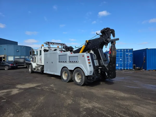 Side view of INT-35 heavy wrecker showcasing underlift and hydraulic boom for recovery operation