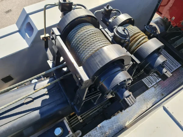 Close-up of dual heavy-duty winch drums and steel cable system on INT-35 integrated wrecker