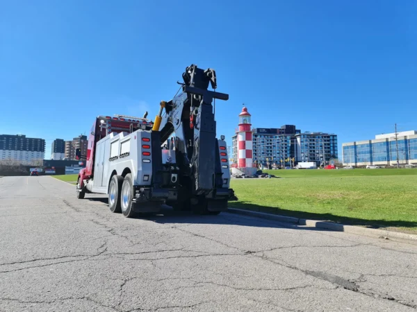 Rear view of INT-35 heavy-duty integrated wrecker with boom raised on paved roadway