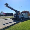 INT-35 integrated wrecker deploying extended boom on roadside grass area