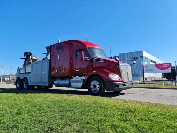 Red and gray INT-35 heavy-duty tow truck with integrated boom and underlift ready for deployment
