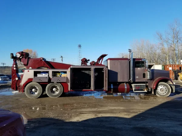 INT-35 integrated wrecker with equipment compartments open displaying towing and recovery gear