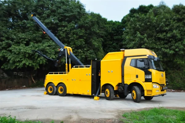 INT-60 heavy duty integrated wrecker in yellow, boom raised for highway towing and recovery operations