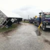 INT-60 heavy wrecker recovering overturned commercial trailer from roadside ditch