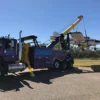 INT-60 integrated wrecker lifting a broken plane with boom extended during recovery operation