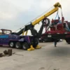 INT-60 heavy duty integrated wrecker supporting a INT-60 heavy duty integrated wrecker supporting a trailer recovery with stabilizers and boom deployed