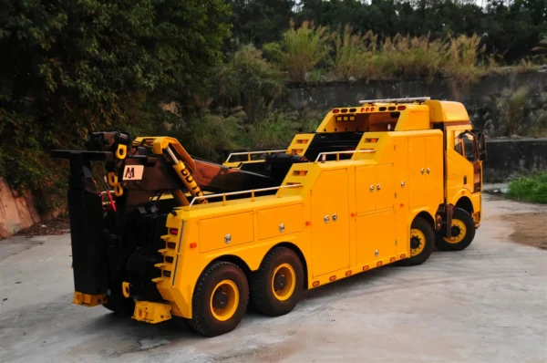 Rear right view of yellow INT-60 integrated wrecker